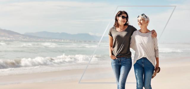 Mother and daughter walking on the beach